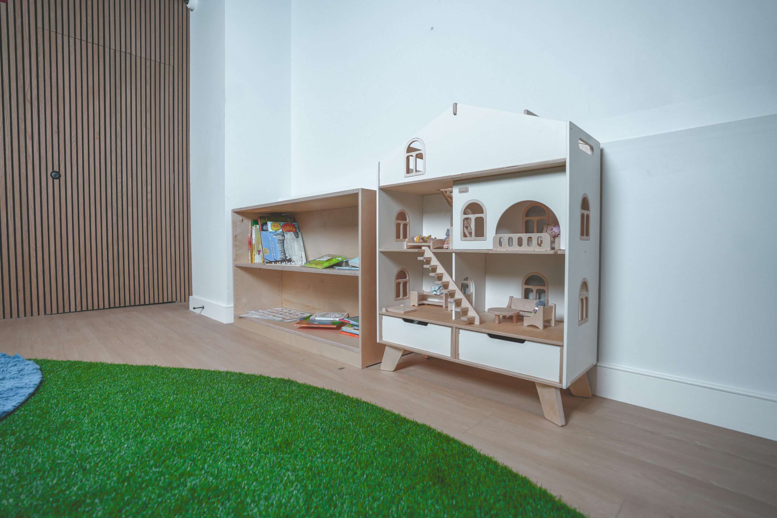 Recess classroom with open wood shelving and natural light